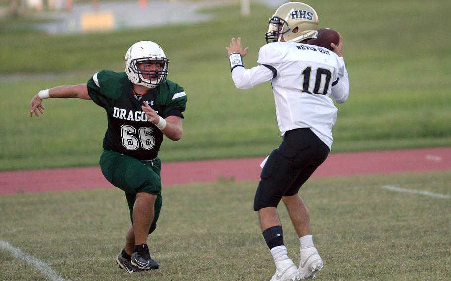 Kubasaki's Evan Swan draws a bead on Humphreys' quarterback Bradley Miller.