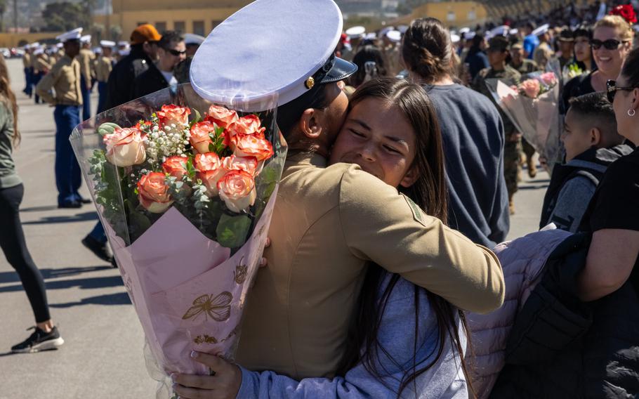 A new U.S. Marine is greeted with a hug