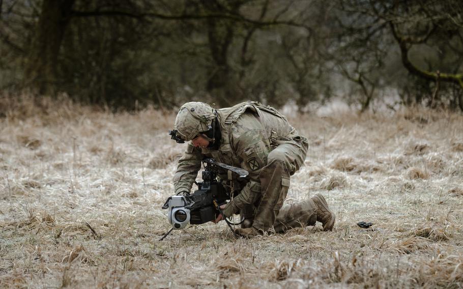 A U.S. soldier attaches a battery to a drone.