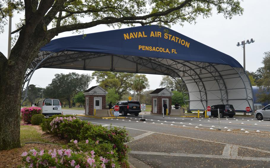 A car stops at the guardhouse at the gate at NAS Pensacola.