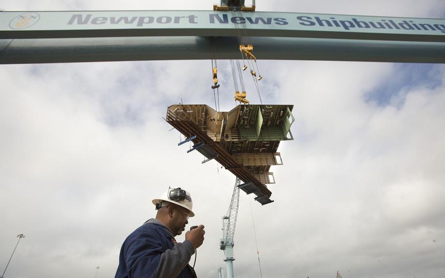 The final primary hull structure, the forward end of one of the ship’s catapults, is lifted by Big Blue, the gantry crane at Newport News Shipbuilding, to the aircraft carrier Gerald R. Ford under construction in Newport News on May 7, 2013.