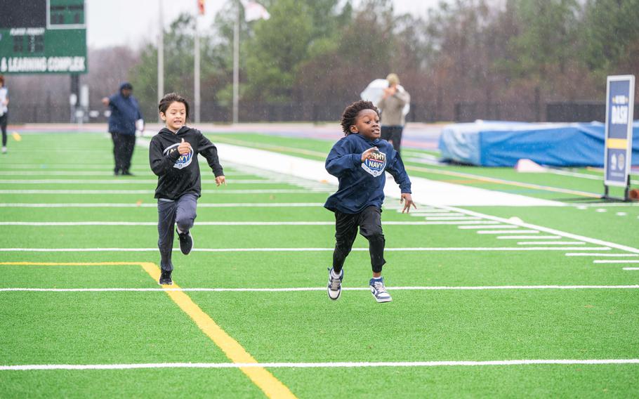 Local kids and caregivers from military and veteran families participate in the 40-yard dash drill