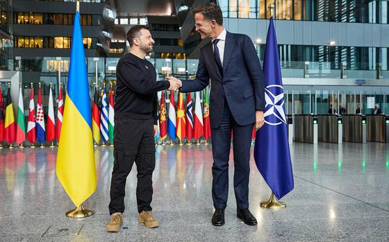 Ukrainian President Volodymyr Zelenskyy shakes hands with NATO Secretary-General Mark Rutte after arriving at the alliance's headquarters for talks, Oct. 17, 2024.