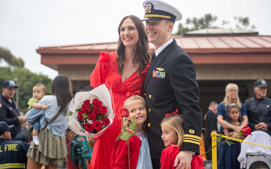 U.S. Navy Lt. Cmdr. Christian Colburn hugs his family 