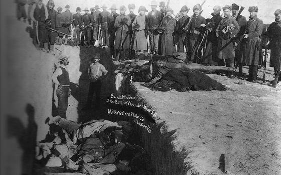 This undated photo shows the dead being buried in a common grave at Wounded Knee, S.D., in the aftermath of the Dec. 29, 1890, Battle of Wounded Knee.