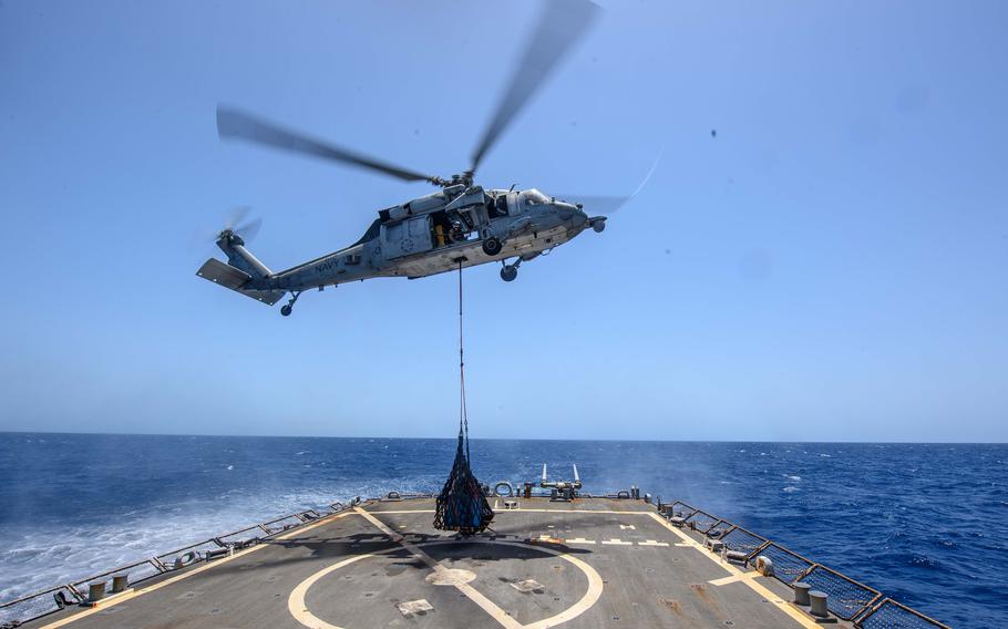 An MH-60S Sea Hawk helicopter delivers supplies to the Arleigh Burke-class guided-missile destroyer USS Laboon in the Red Sea, May 14, 2024. Laboon is deployed to the U.S. 5th Fleet area of operations to support maritime security and stability in the Middle East region. 