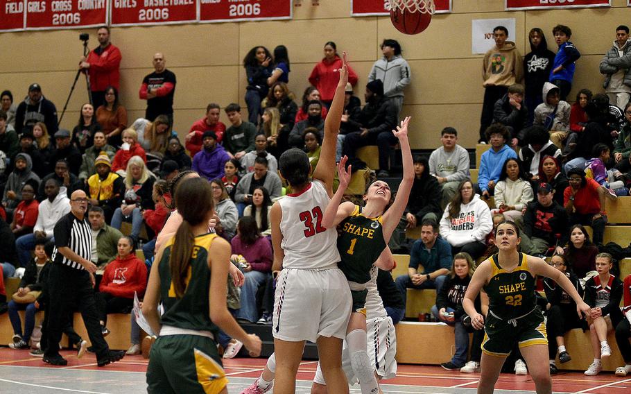 SHAPE's Jessica Moon shoots while Kaiserslautern's Emma Arambula defends during a Jan. 12, 2024, game at Kaiserslautern High School in Kaiserslautern, Germany.