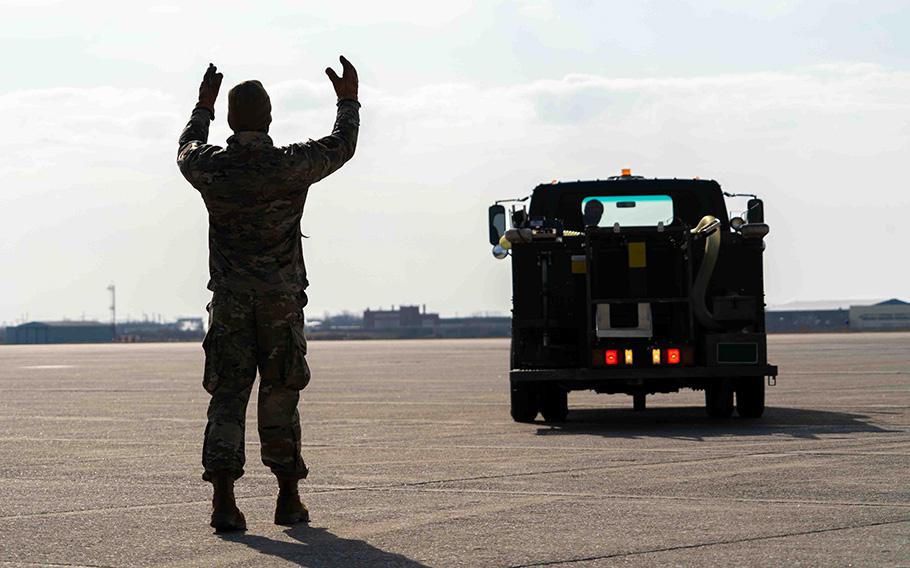 A 914th Air Refueling Wing Aircraft Maintainer guides a sewage truck driver close to a KC-135 to remove human waste from the aircraft prior to its next departure from Niagara Falls Air Reserve Station, N.Y., on March 21, 2023.