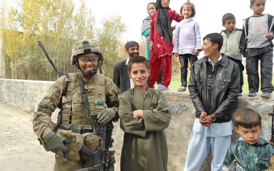 Motupalli poses with civilians in Afghanistan’s Logar province. 