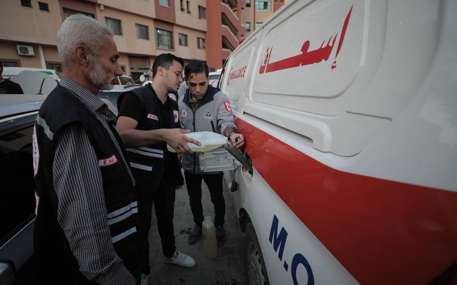 Paramedics attempt to fill up the fuel tank of their ambulance with petroleum jelly used for first aid at the Nasser Medical Hospital in Khan Younis in the southern Gaza Strip on Tuesday, Oct. 17, 2023.