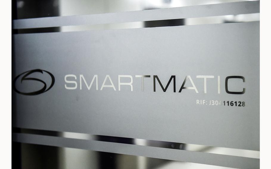 Picture of the logo of Smartmatic, the firm that supplies Venezuela’s voting technology, seen on a sliding door at the headquarters of the company in Caracas, on Aug. 2, 2017. 