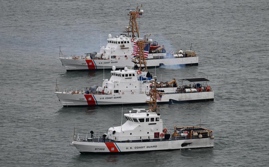 Three Coast Guard vessels next to each other.