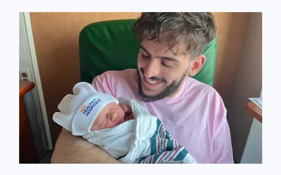 Rafael Abitbul holds his son. 