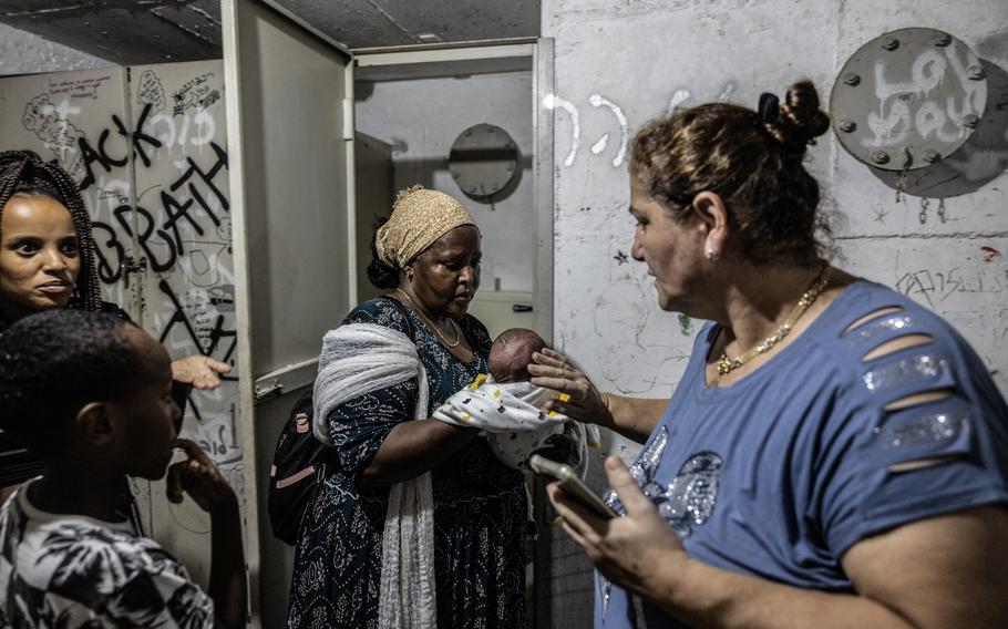 Ethiopian Ukrainian Israelis in a bomb shelter in Kiryat Bialik, Israel