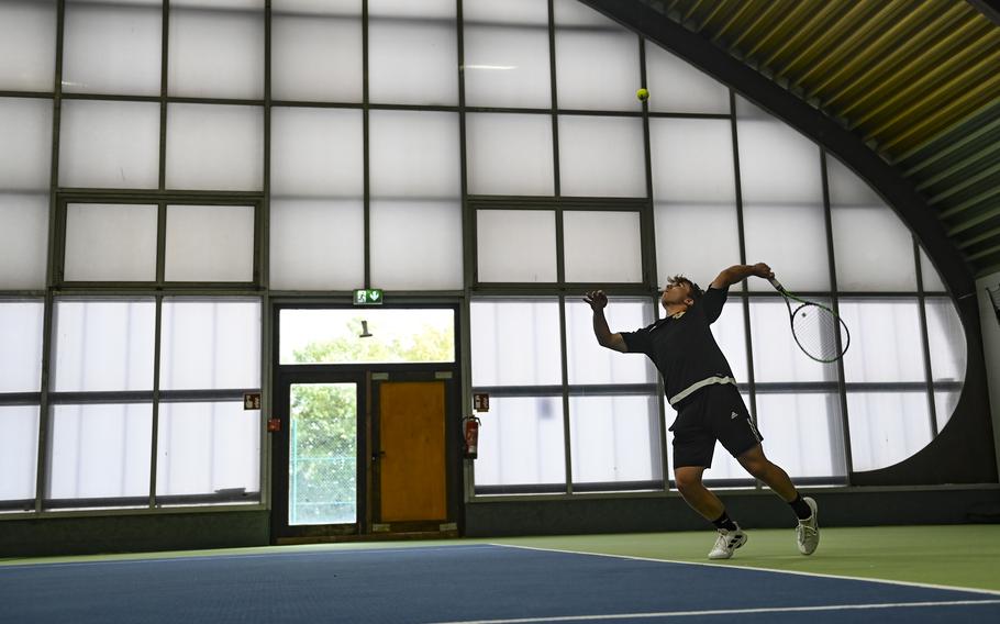 Stuttgart’s Hunter Leslie-Persons, teamed with Zachary Call, delivers a precise serve against Bahrain’s duo, Carson Owens and Matthew Mendoza, during the DODEA European tennis championships at T2 Sports Health Club in Wiesbaden, Germany, on Oct. 21, 2023.