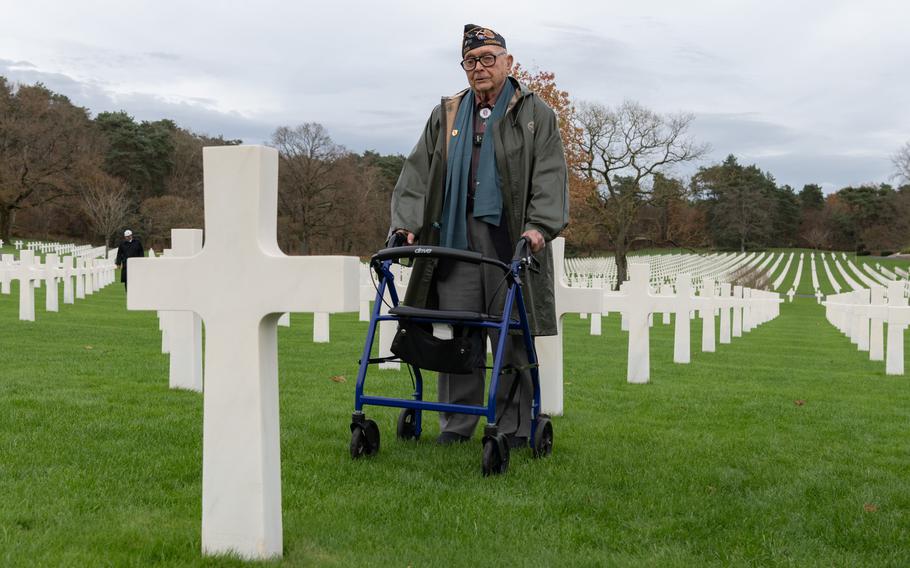 Veteran Ceo Bauer stands before the grave of a soldier he knew in the cemetery at Saint-Avold, France.