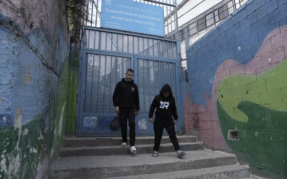 Two youths leave a boys school run by the United Nations agency for Palestinian refugees, known as UNRWA, in the Shuafat refugee camp in Jerusalem, Monday, Jan. 27, 2025. (AP Photo/Mahmoud Illean)