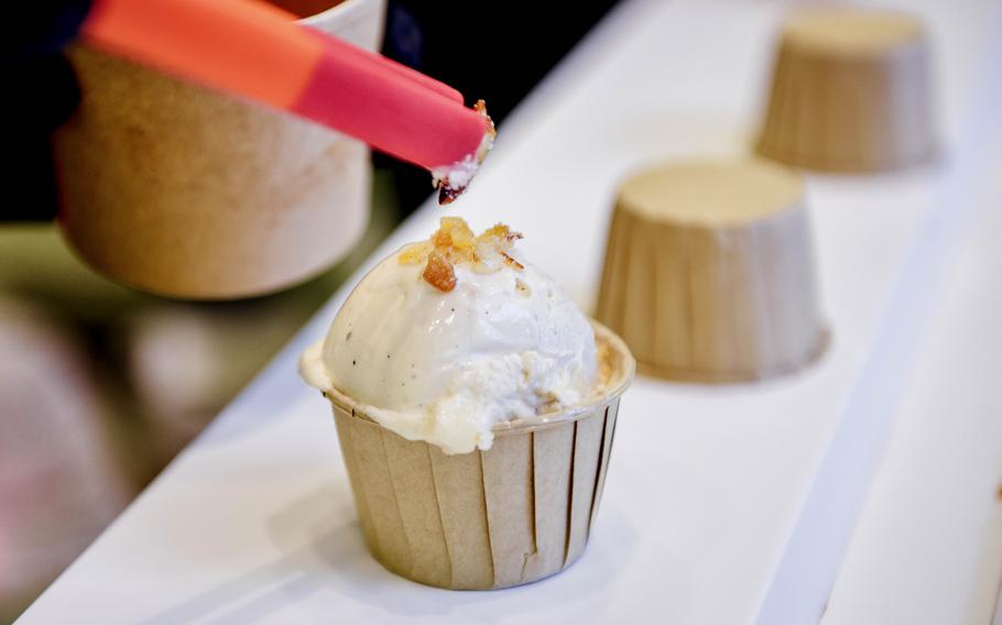 A cup of ice cream receives a topping at a shop in Bahrain.