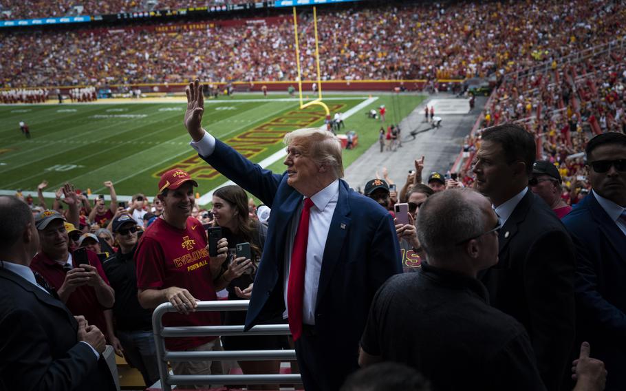 Trump waves to the crowd before the start of an NCAA college football game at Jack Trice Stadium on Sept. 9, in Ames, Iowa.