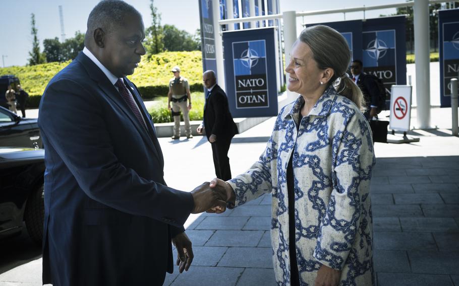 U.S Ambassador to NATO Julianne Smith greets Defense Secretary Lloyd Austin in June 2022 for a meeting of the Ukraine Defense Contact Group at NATO headquarters in Brussels, Belgium. 