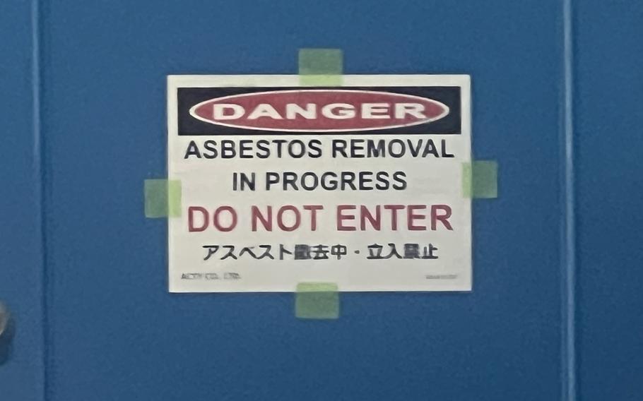 A sign in English and Japanese warns that asbestos is being removed from the Mediterranean Bistro at Yokota Air Base, Japan, July 10, 2023. 