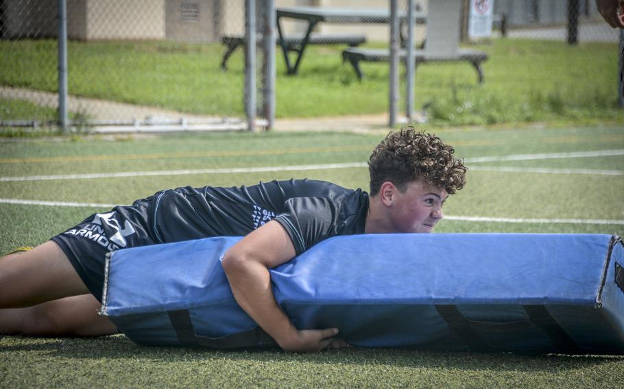 Crew Flatau, a ninth grade student of Osan Middle High School, performs a drill during football practice at Osan Air Base, South Korea, Monday, Aug. 5, 2024.