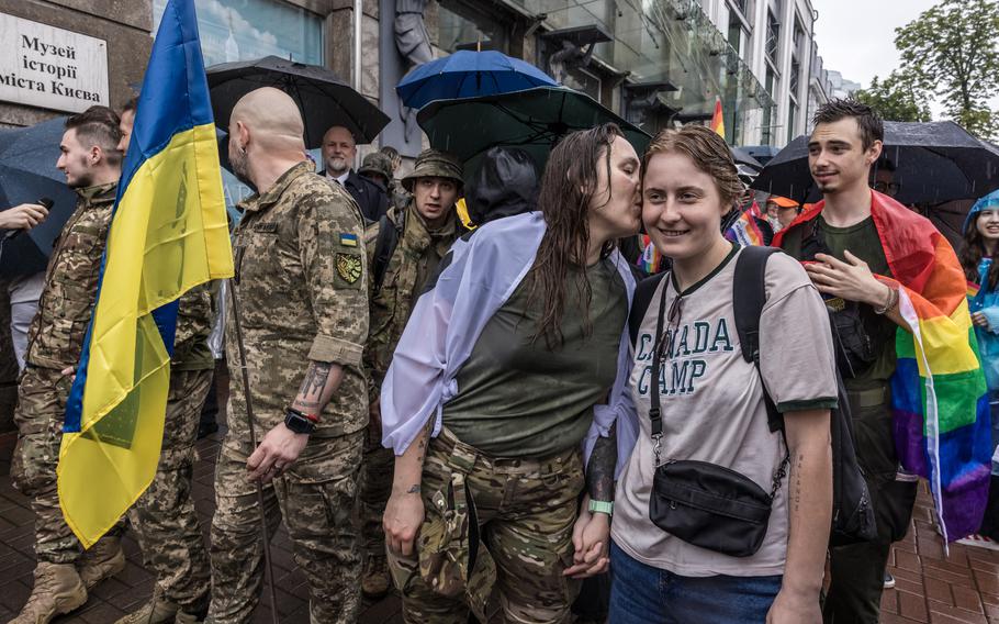 Volia, second from right, kisses her partner, Diana Harasko, at the Kyiv Pride on Sunday. 