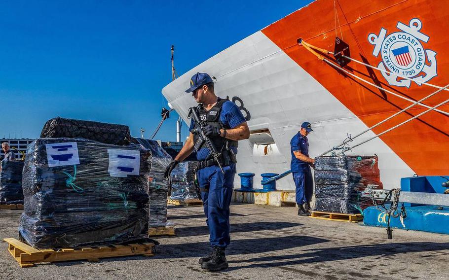 U.S Coast Guard officers set up pallets