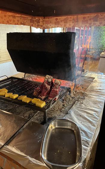 Meat being grilled at an Italian restaurant.