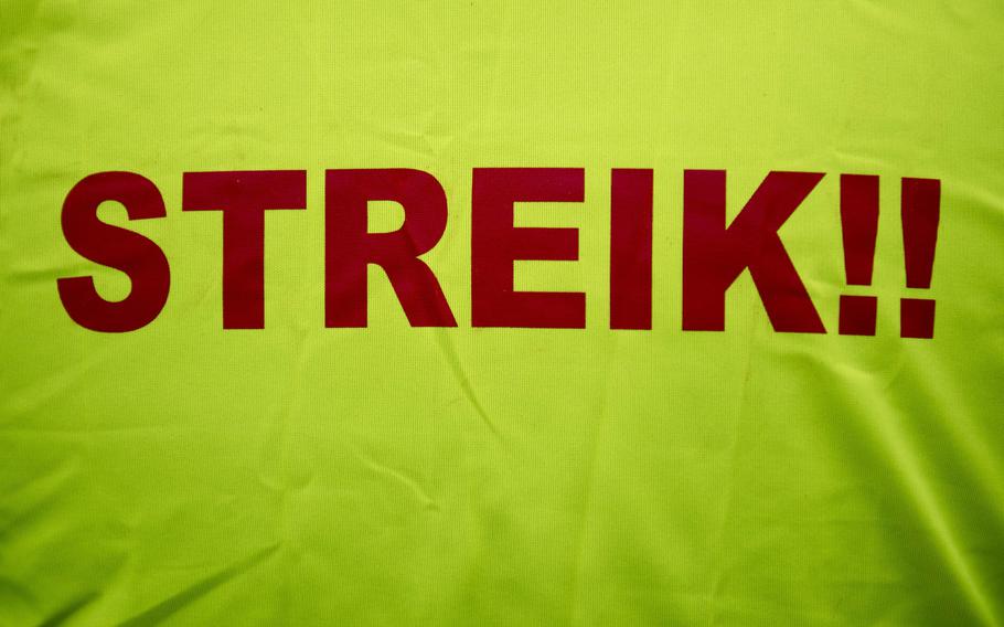 Streik!! is printed on a vest. It’s the German word for strike.