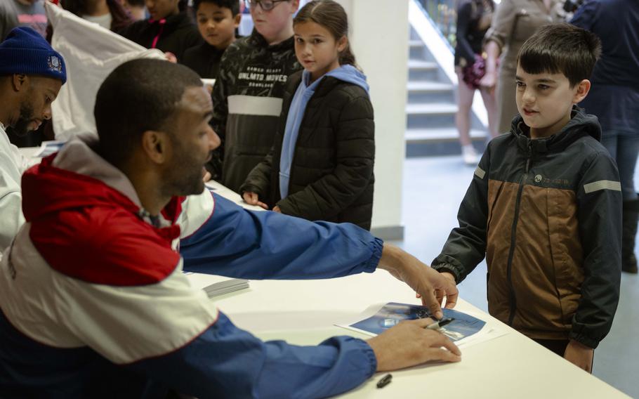 Brandon London, a former wide receiver for the New York Giants, talks to a student at Vilseck Elementary School in Germany on Thursday. 