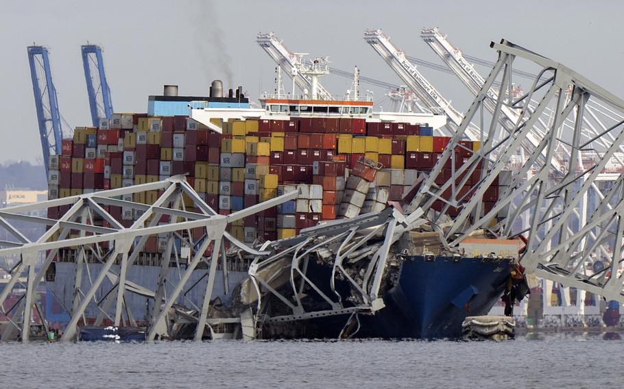 The cargo ship Dali is stuck under part of the structure of the Francis Scott Key Bridge after the ship hit the bridge March 26, 2024.