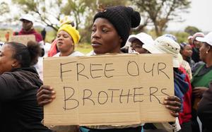 FILE - Relatives and friends protest near a reformed gold mineshaft where illegal miners are trapped in Stilfontein, South Africa, Friday, Nov. 15, 2024. (AP Photo/Denis Farrell, File)