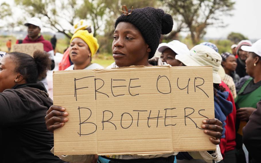 Relatives and friends protest near a reformed gold mineshaft