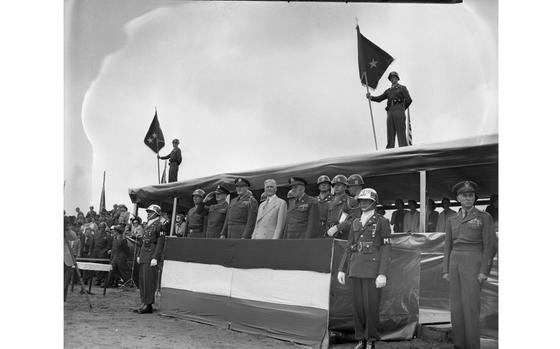 Grafenwoehr Parade Ground, Germany, June 3, 1950: Members of the reviewing party come to attention as the colors are paraded past the reviewing stand. 

The Big Red One - the Fighting First - celebrated the 33rd anniversary of its founding weith a full-dress review on the huge Grafenwoehr parade ground. More than 20,000 soldiers marched past their commander, Maj. Gen. John E. Dahlquist, his honor guests, Lt. Gen. Clarence R. Huebner, the Commanding General of the USAREUR; Maj. Gen. Frank W. Milburn, depute Commanding General USAREUR and a large number of military officials on hand for the Organization Day ceremony.

Much of the digitization of Stars and Stripes' negatives and photo prints occurs because the film or print has preservation issues. Archives staff conducted a preservation survey of its film-based collection in 2018 to identify film types and years showing signs of any deterioration and prioritized those for digitization.

One of the preservation issues found in our film collection can be seen here: the so called "silvering" or "silver mirroring" of silver based film which appears as a metallic sheen (seen here most in the top left and right sky) and occurs when the silver in the film starts to break down and moves to the surface. Irreversable it can - over time - destroy the image.  


META TAGS:  1st Infantry Division; Big Red One; U.S. Army; ceremony; parade; Archives Month