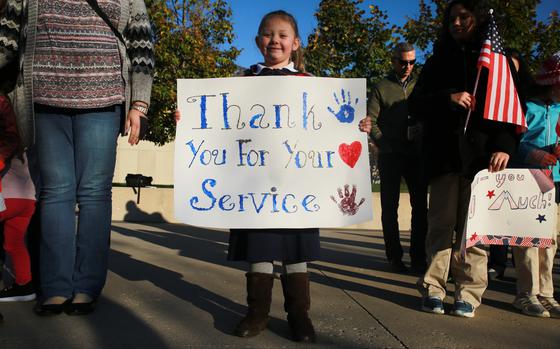 A girl holds a sign welcoming veterans of World War II and the Vietnam and Korean wars outside the National Museum of the Marine Corps in Triangle, Va., on Nov. 2, 2019. Many young veterans are uncomfortable with the phrase thank you for your service, a recent USAA survey found. Most veterans over age 45 said it didn't bother them.