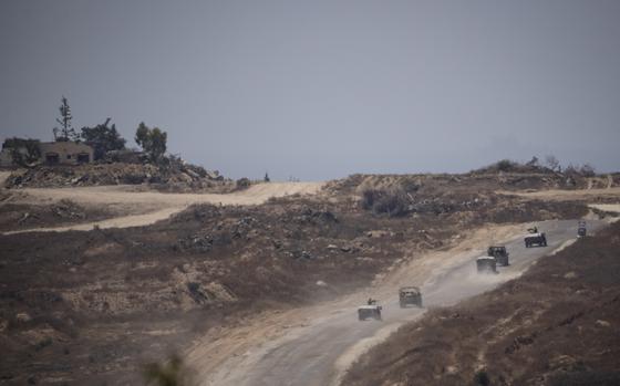 Israeli soldiers move near the Israeli-Gaza border as seen from southern Israel, Monday, June 10, 2024. 