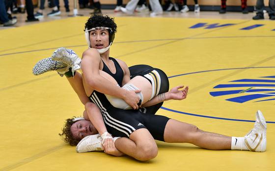 Vilseck's Jayden Freeman looks toward the referee while trying to pin Vicenza's Paul Sturtevant during a 150-pound pool-play match at the 2025 DODEA European wrestling championships on Feb. 7, 2025, at the Wiesbaden Sports and Fitnes Center in Wiesbaden, Germany.