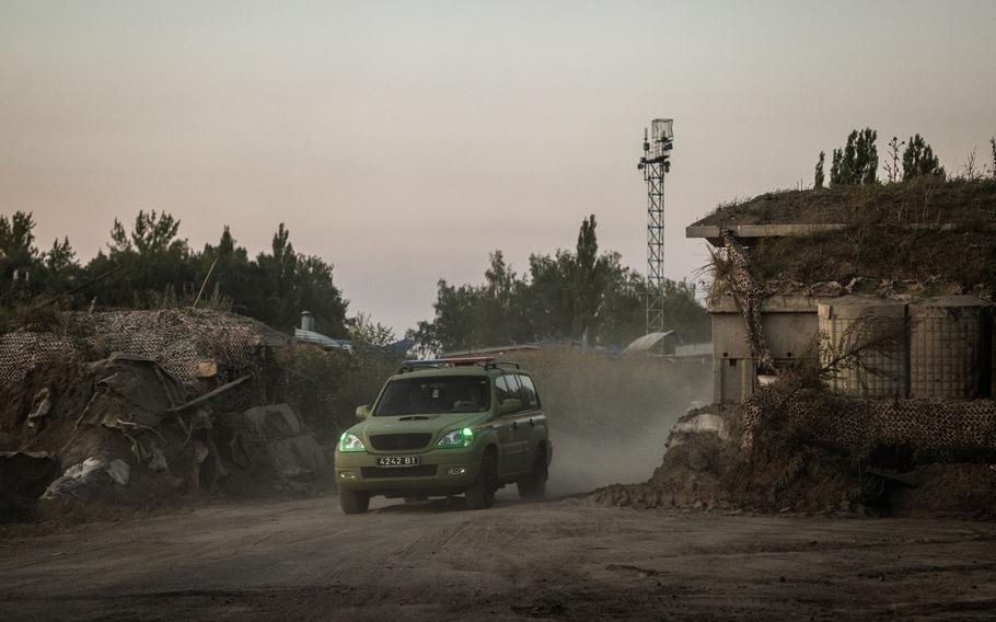 A vehicle is driven through a destroyed border post at the border between Ukraine and Russia in Ukraine’s Sumy region on Aug. 15. 