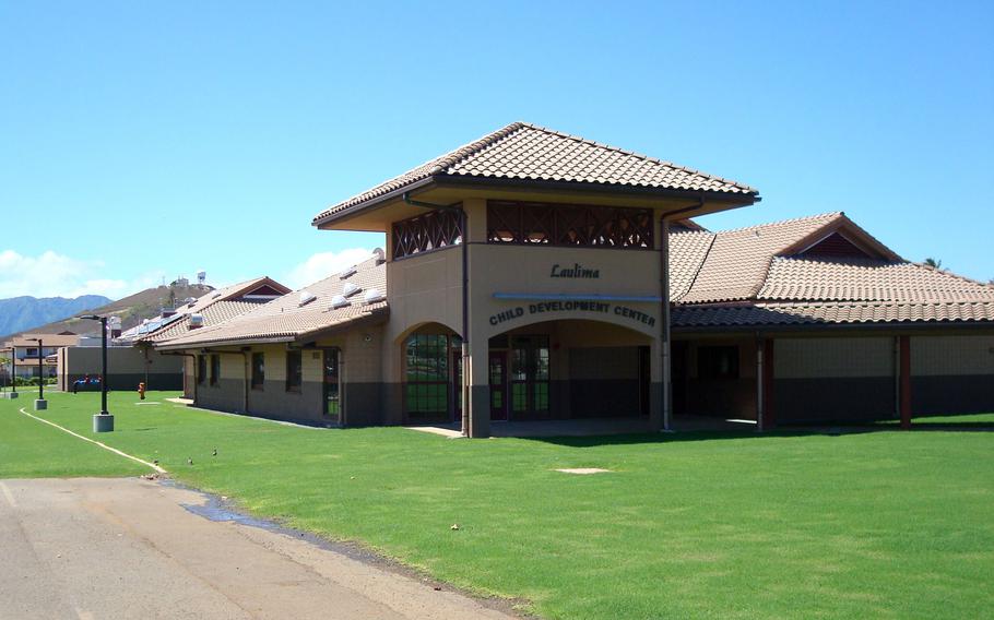 A beige Child Development Center building contrasts with a blue sky.