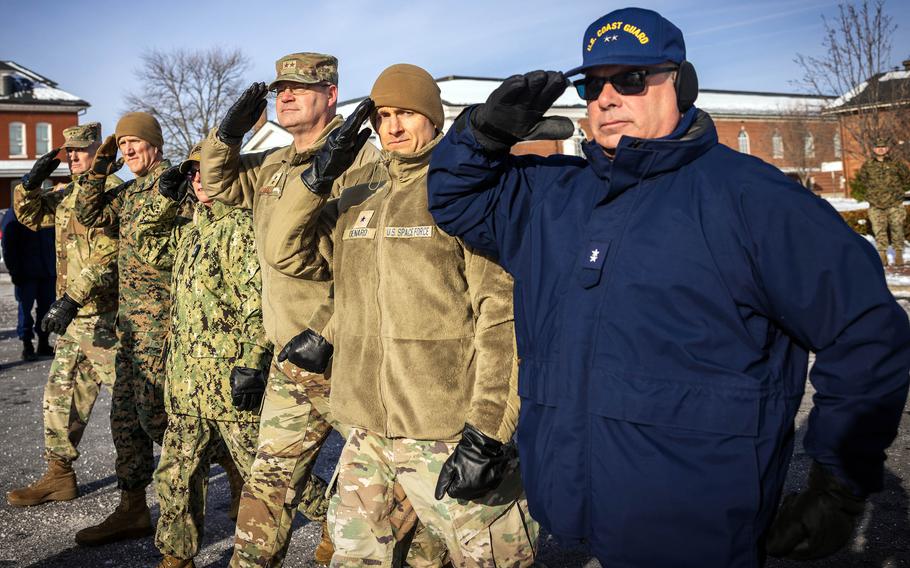 U.S. troops salute while rehearsing for the presidential inauguration.