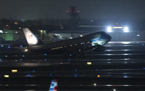 Air Force One on the runway at night.