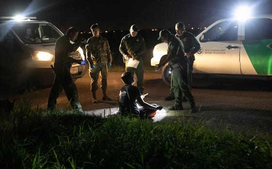 U.S. Border Patrol agents communicate with an undocumented immigrant from China on a smart phone translation app on Sept. 10, 2019, in Mission, Texas. (John Moore/Getty Images/TNS)