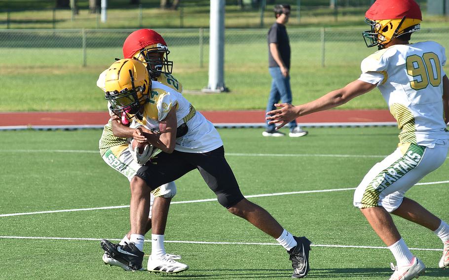 SHAPE junior Chris Carter tries to power through a tackle attempt by Jorge Bernal during an Aug. 27, 2024, practice in Mons, Belgium.