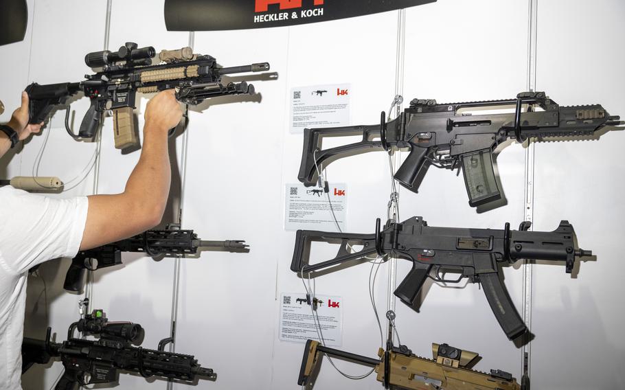 An attendee takes down a Heckler & Koch rifle