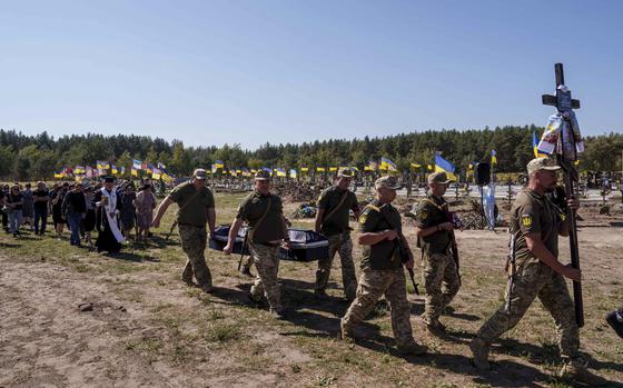 Ukrainian servicemen carry the coffin of their comrade Serhiy Dondiuk, killed in a Russian rocket attack at a Ukrainian military academy, during the funeral ceremony in Poltava, Ukraine, Saturday Sept. 7, 2024. (AP Photo/Evgeniy Maloletka)