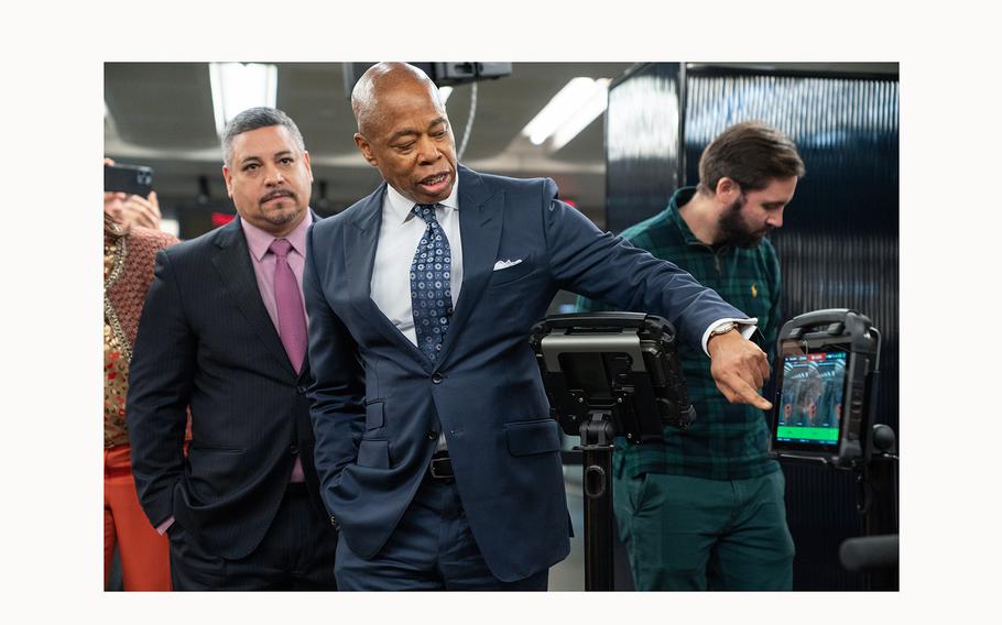 New York Mayor Eric Adams points out a weapon that was caught by a weapons detections system during a on March 28, 2024, briefing announcing weapons detectors for the NYC subway system in the Fulton Transit Center in New York. 