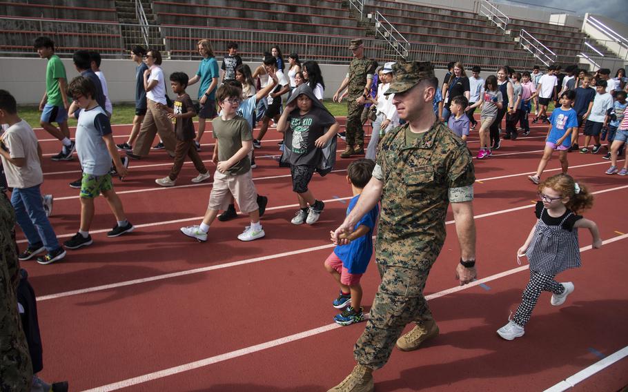 Students, teachers and parents remember the 9/11 attacks with a freedom walk at Matthew C. Perry High School on Marine Corps Air Station Iwakuni, Japan, Wednesday, Sept. 11, 2024.