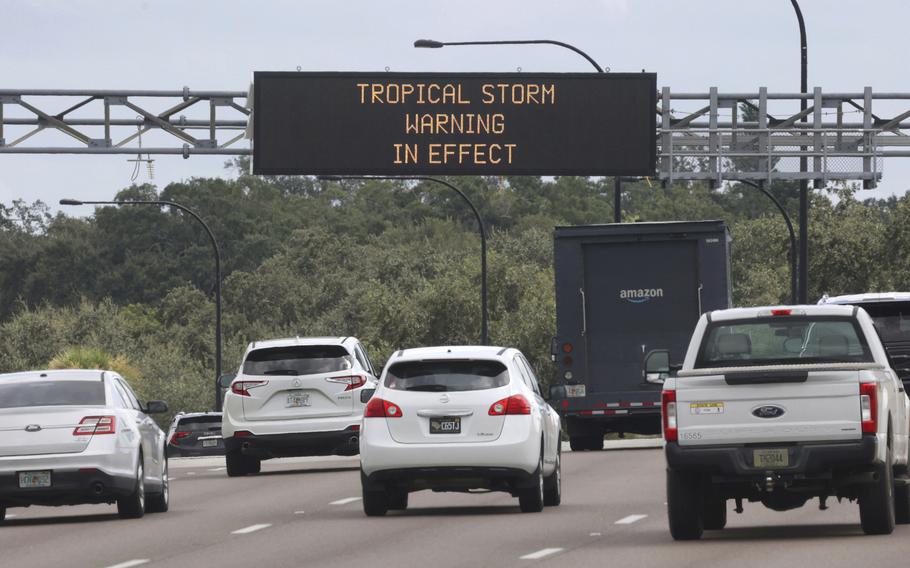 A traffic advisory sign warns of a tropical storm