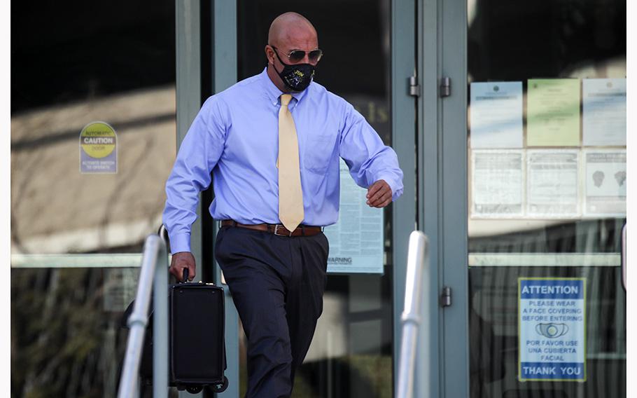 John Olivas, a former U.S. Homeland Security agent, exits the federal courthouse in Riverside in December 2021. 